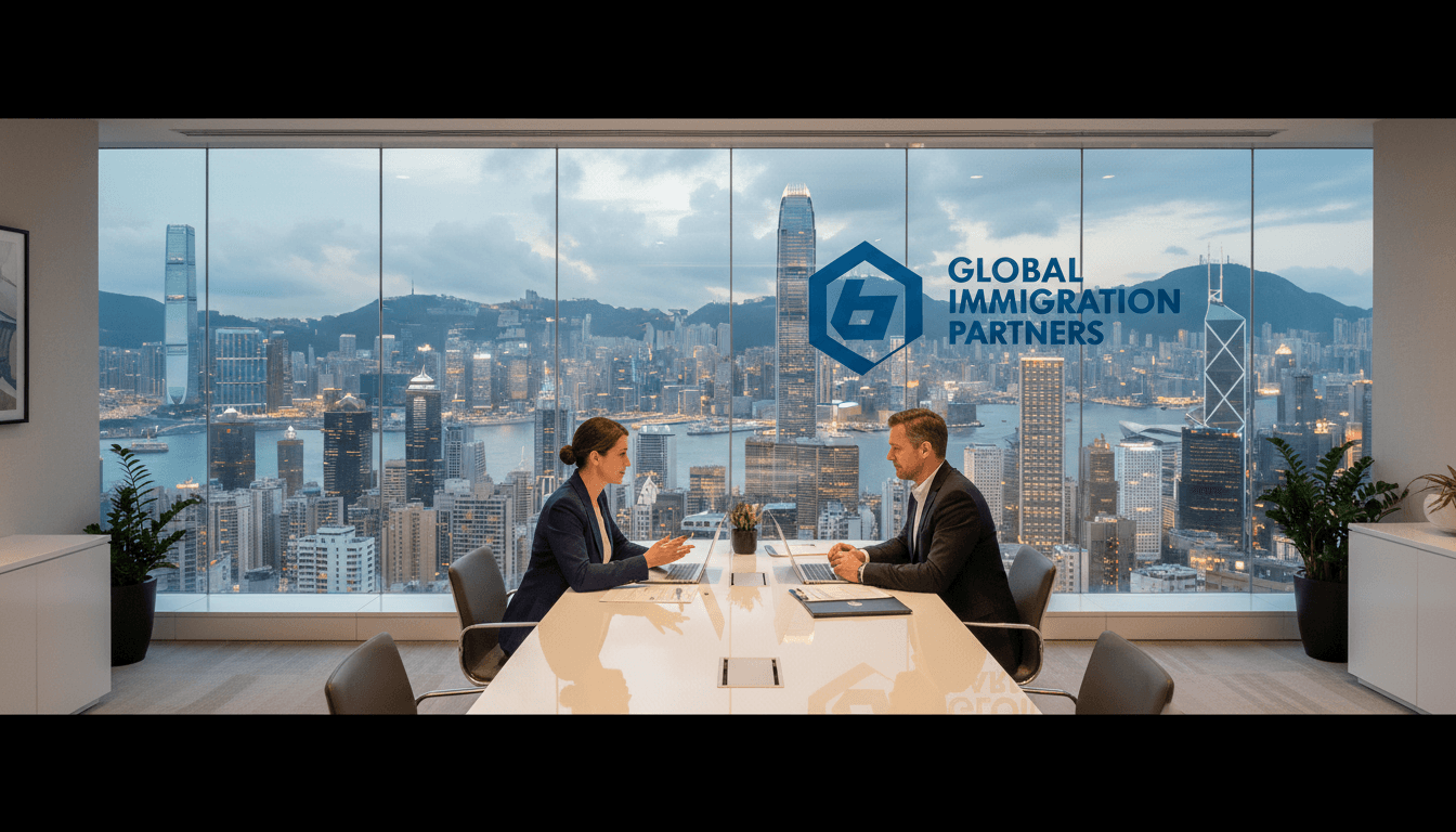 Immigration consultant reviewing QMAS application documents with client in professional Hong Kong office